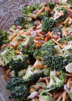 broccoli and other vegetables are mixed together in a bowl with a pink polka dot border