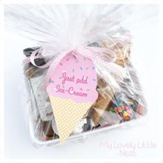 a bag filled with lots of cookies and candy next to a sign that says just add ice cream