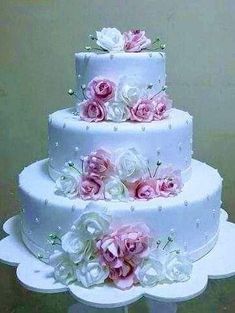 three tiered wedding cake with pink and white flowers