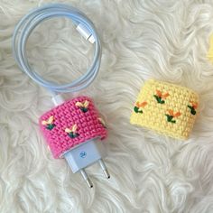 three crocheted items sitting on top of a white furnishing covered floor