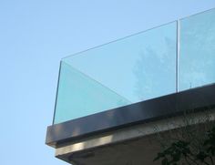 the top of a building with a glass railing