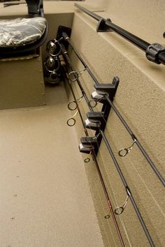 fishing rods are attached to the side of a boat's hulls and seat