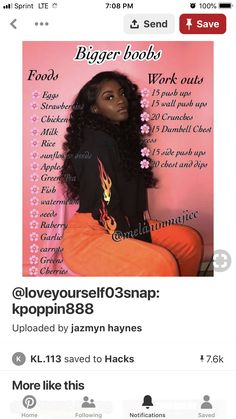 a woman sitting on top of an orange chair next to a pink wall with words above her