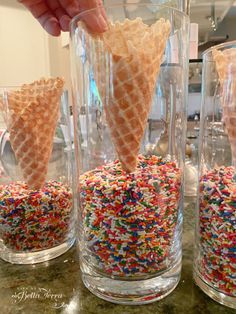 three glasses filled with sprinkles and ice cream cones