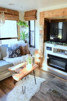 a living room filled with furniture and a flat screen tv mounted on a wall above a fire place