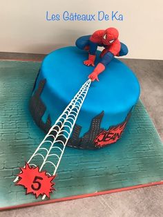 a spiderman cake with the number five on it