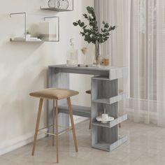 a room with a table and stools in it, next to a wall mounted shelf