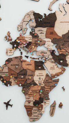 the world map is made out of wooden pieces