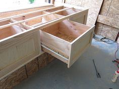 an unfinished kitchen cabinet is being built