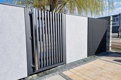 the gate is made of black metal and has vertical slats on it's sides