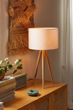 a wooden table with a lamp on top of it and some books next to it