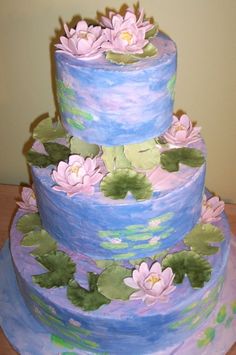 a three tiered cake with water lilies on it