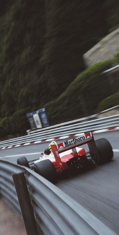 a man driving a racing car down a race track