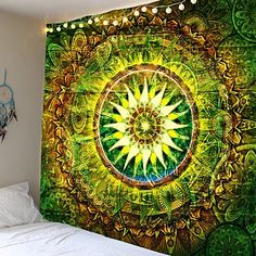 a bedroom with a green and yellow wall hanging on the wall next to a bed