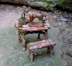 an old wooden table with two small stools and a sewing machine sitting on top of it