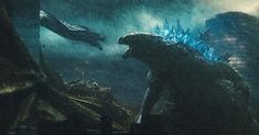 godzilla in the rain with his mouth open, and another creature standing next to him