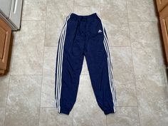 These pants are super hip, and fantastic. They are old school Adidas. They are lined for your comfort. They must be bought to be worn.   Brand: Adidas Size: Large Material: Nylon polyester rayon Measurements in inches Waist 30-36 Inseam 30  13.4 #7 I do accept returns within 30 days of purchase of all vintage items. The item must be in the same condition in which it shipped and preferably with the tags still on. The customer is responsible for all shipping costs and there is a 20% restocking fee Old School Adidas, Adidas Hose, Adidas Vintage, 90s Mens, Pants Blue, Adidas Pants, Vintage Adidas, Mens Trousers, Halloween Shopping