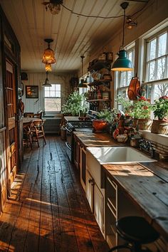 an old fashioned kitchen with wooden floors and lots of potted plants