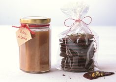 a jar filled with chocolate cookies next to a bag of cookies