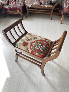 a wooden rocking chair sitting on top of a hard wood floor next to a couch