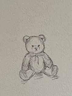 a drawing of a teddy bear sitting on the ground