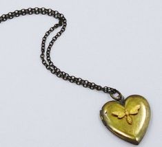 "Oh so sweet. A vintage art heart  Locket necklace measures 1 '\" across. You can add photos to both sides.  This fabulous vintage bee locket is suspended from an 18\" antiqued brass chain embellished with a super cute stylish bee very girly, a fabulous addition to any jewel box." Vintage Antique Gold Heart Pendant Necklace, Antique Gold Heart Pendant Vintage Necklace, Vintage Necklace For Valentine's Day, Vintage Antique Gold Keepsake Necklace, Vintage Heart Necklace With Charm For Anniversary, Vintage Necklaces With Vintage Charm For Valentine's Day, Vintage Heart Necklace With Vintage Charm For Anniversary, Vintage Pendant Locket Necklace For Valentine's Day, Personalized Vintage Heart Necklace