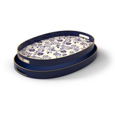 a blue and white tray with floral designs on the bottom, sitting in front of a white background