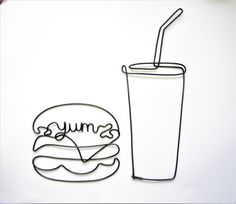 a paper cut out of a hamburger and a drink with a straw in the cup