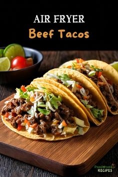 three beef tacos on a wooden cutting board