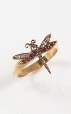 Offering this splendid feminine petite 10k rose gold Victorian dragonfly diamond & garnet insect ring. This ring was repurposed from an antique 10k rose gold pin, and the head was welded by our jeweler to a modern 10k yellow gold ring shank.  Ring is a size 6.25 and has a total weight of 2.3 Grams. Dragonfly portion of ring is 1/2"L by 5/8"W and is unmarked but tested as 10K. Ring is presented in very good overall condition with normal wear for age. (See magnified photos). Thanks for viewing, please check out our other auctions. Total Weight: Approximately 2.3 Grams Dragonfly is 1/2"L x 5/8"W Hallmarked 10K Ring, Unmarked Tested 10K Dragonfly Victorian Era Dragonfly Approximate Ring Size: 6.25 Dragonfly Jewelry Rings, Insect Ring, Dragonfly Ring, Antique Jewelry Rings, Dragonfly Jewelry, Ring Shank, Gold Pin, Yellow Gold Ring, Victorian Era