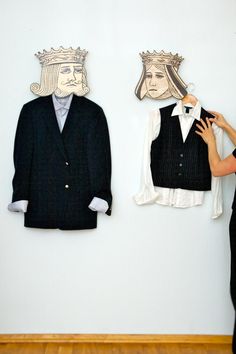 a woman standing next to two pieces of paper cut out of clothes