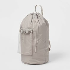 a grey backpack with mesh draws on the front and side pockets, sitting against a white background