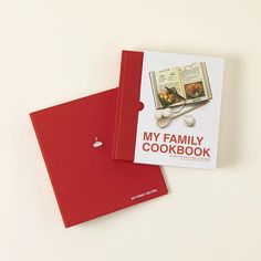 two red cookbooks sitting next to each other