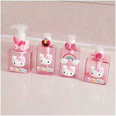 hello kitty soap dispensers are lined up in a row on the counter