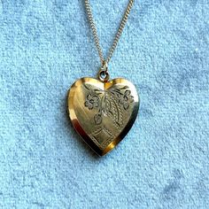 vintage 10k gold filled locket from the 1950s with hand engraved detail on 16" handmade 14k gold filled chain  chain can be extended upon request via messages Vintage 14k Gold Necklace In Antique Gold, Gold Engraved Heart Necklace For Wedding, Antique Gold 14k Stamped Jewelry As Gift, Vintage 14k Gold Antique Gold Necklace, Antique Gold Jewelry Stamped 14k As Gift, Vintage 14k Antique Gold Necklace, Gift Antique Gold Jewelry Stamped 14k, Gold Heart Necklace Stamped 14k For Wedding, Vintage 14k Gold Necklaces For Anniversary