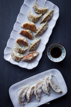 some dumplings are sitting on a white plate