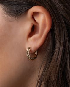 These 14k gold bubbled edge and ribbed huggie earrings are the perfect blend of elegance and attitude. Their chic design and edgy details make them effortlessly stackable for that layered, "I woke up like this" look. Slip these on and show the world that sophistication doesn't have to be boring. Note: To open the earring, press down lightly on the post. It will push down slightly and the back can be opened. Without pressing post while closed, earring will remain in "lock" mode. Outer Diameter: A Modern Gold-tone Huggie Earrings, Modern Gold-plated Tarnish-resistant Huggie Earrings, Hypoallergenic Yellow Gold-plated Huggie Earrings, Elegant Gold-tone Brass Huggie Earrings, Modern Gold-tone Brass Huggie Earrings, Gold Bubbles, Huggie Earrings, Earring Sale, Layered Look