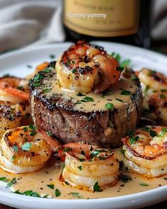 a white plate topped with steak and shrimp