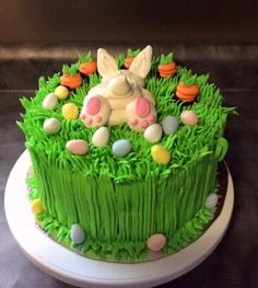 a cake decorated with green grass and eggs