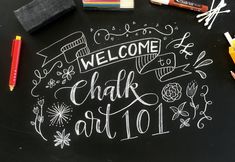 chalk art is written on a blackboard with markers and pencils