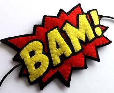 a red and yellow patch with the word bam on it's back side