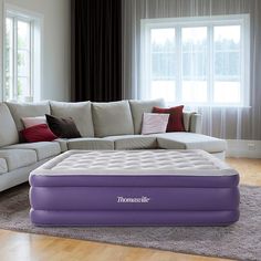 an inflatable mattress sitting on top of a living room floor