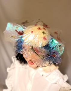 Hat Title: La Perle This is a limited edition hat ie. one of a kind and a one off.  The translucent iridescent sculptural shape has floral motifs embedded inside. It sits atop a small round base that is hand wrapped in layers of iridescent cream/offwhite organza and finished off with guipure lace inside.  The headpiece adheres to your head with a millinery elastic.  Perfect for race days, editorial images, and any occasion that calls for that special something not everyone can get their hands on Mini Hats, Floral Hat, Pink Shades, Guipure Lace, Royal Ascot, Hand Wrap, Race Day, Kentucky Derby, Floral Motifs