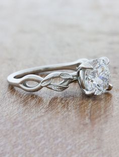 a white gold engagement ring with a twisted vine design