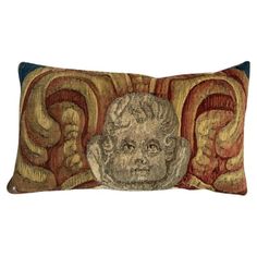 a decorative pillow with an image of a man's head on the front and sides