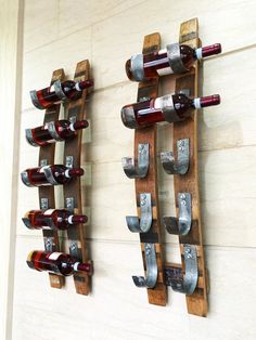 two wooden racks with wine bottles on them are mounted to the side of a wall