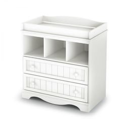 a white baby changing table with drawers