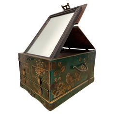 an old green painted chest with mirror on top