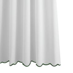 a white shower curtain with green trim on the bottom and side panels, in front of a white background