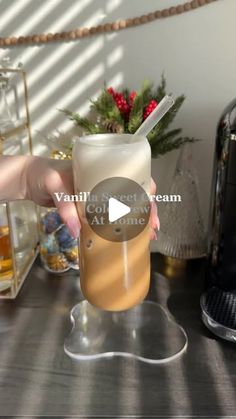 a person holding a glass with liquid in it